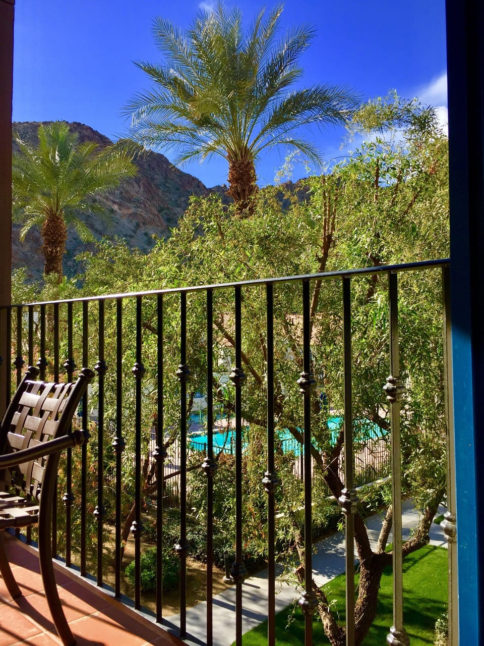 Exterior view from indoors looking to the balcony and pool
