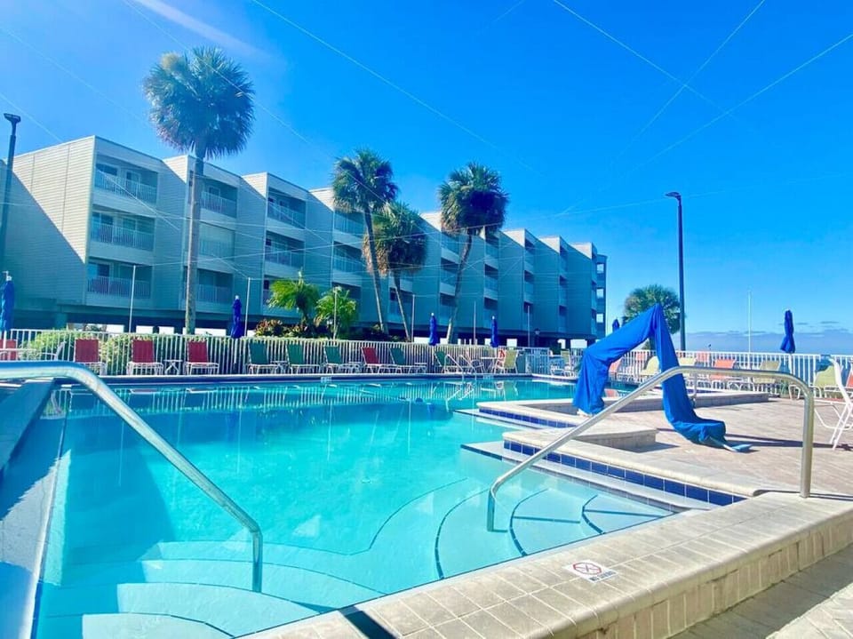Poolside Paradise: Dive into sunshine and palm trees by the inviting poolside oasis!
