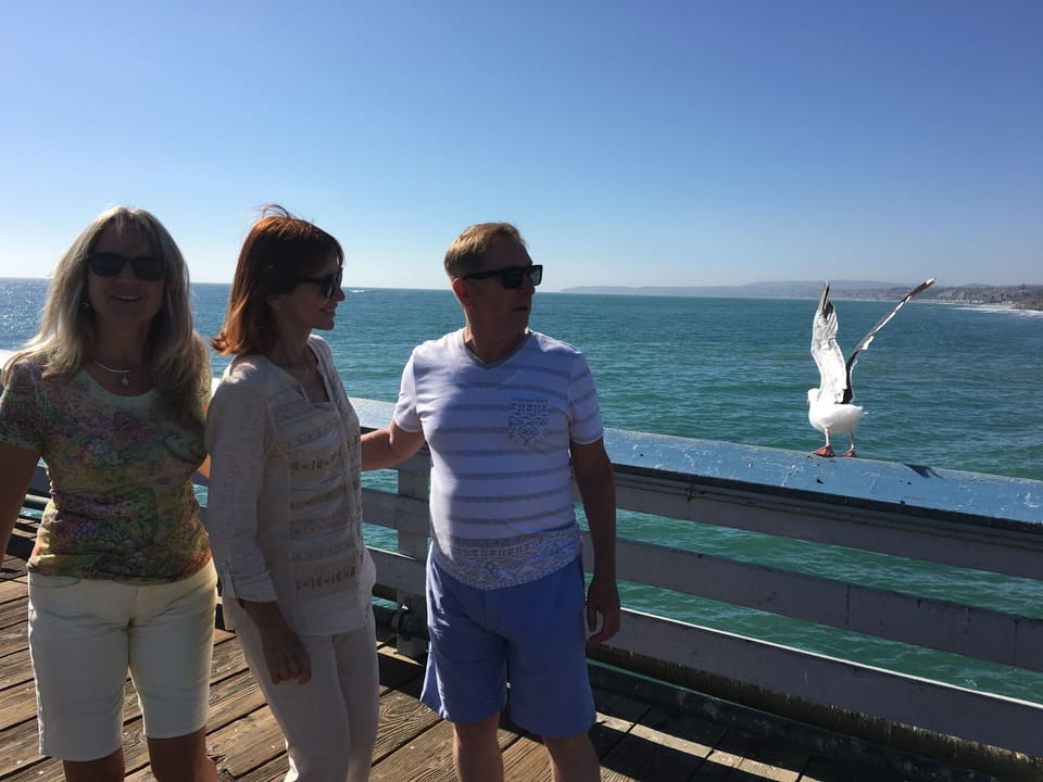 Denise on the Pier with family and seagulls. 