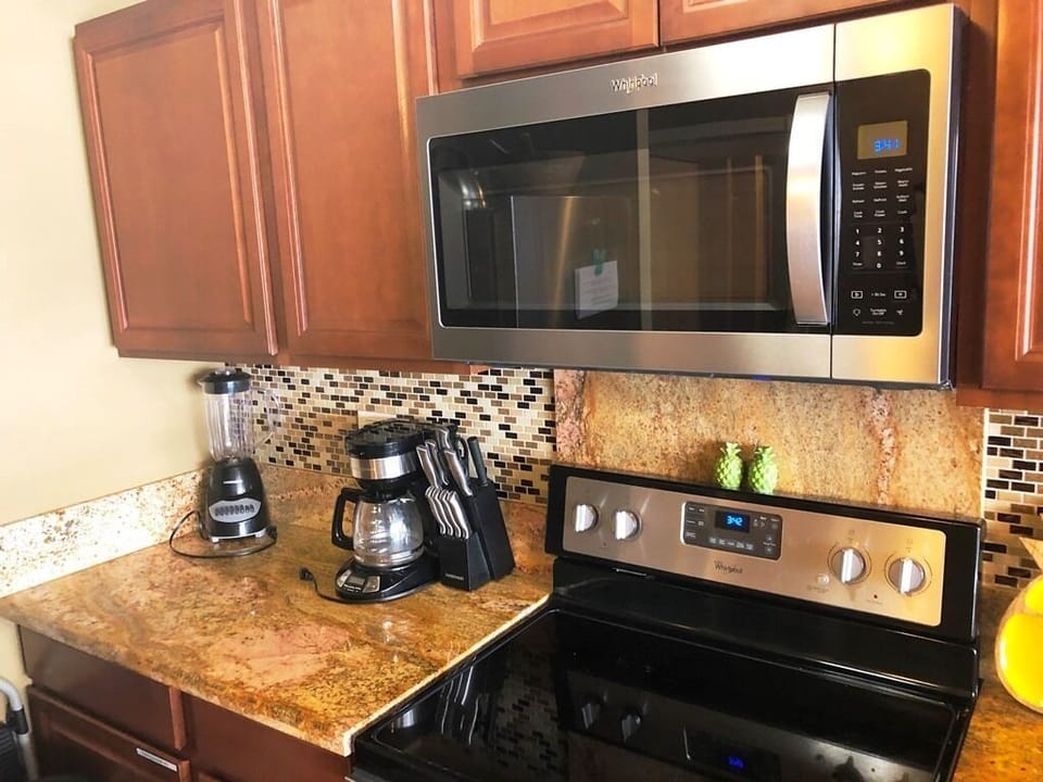 Kitchen has a drip coffee maker and a blender