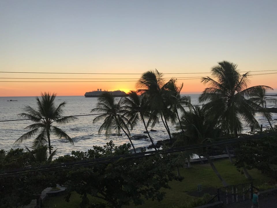 Sunset behind a cruise ship