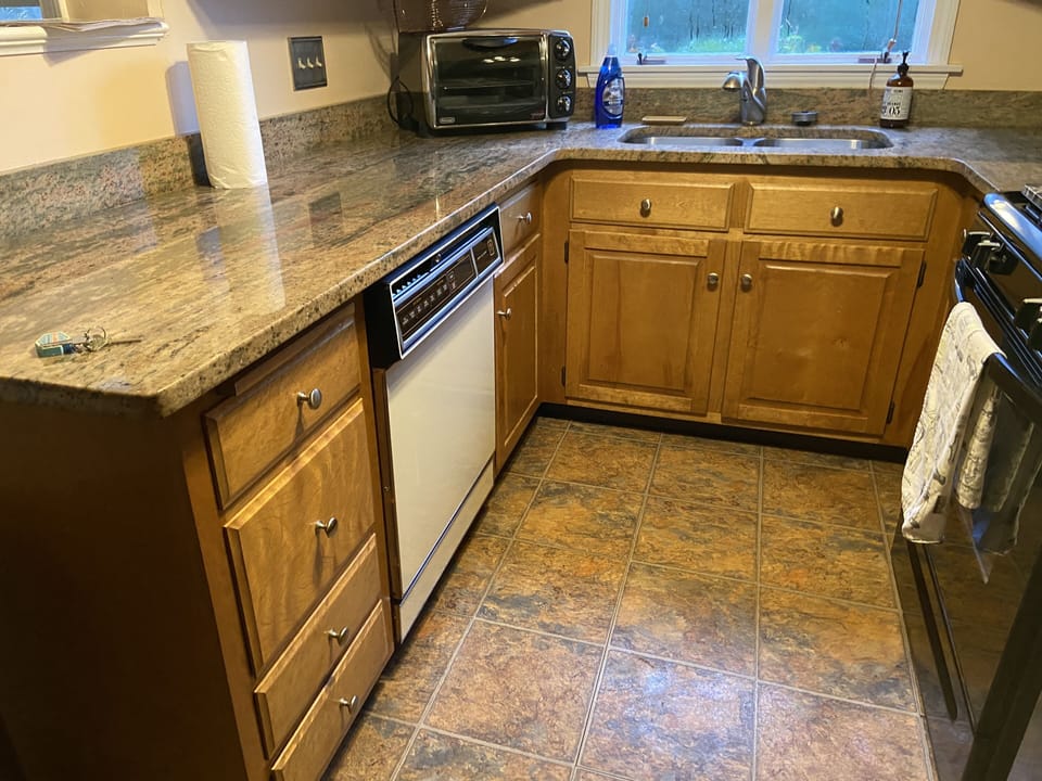 There is a large toaster oven and toaster (not shown) along with a dishwasher 