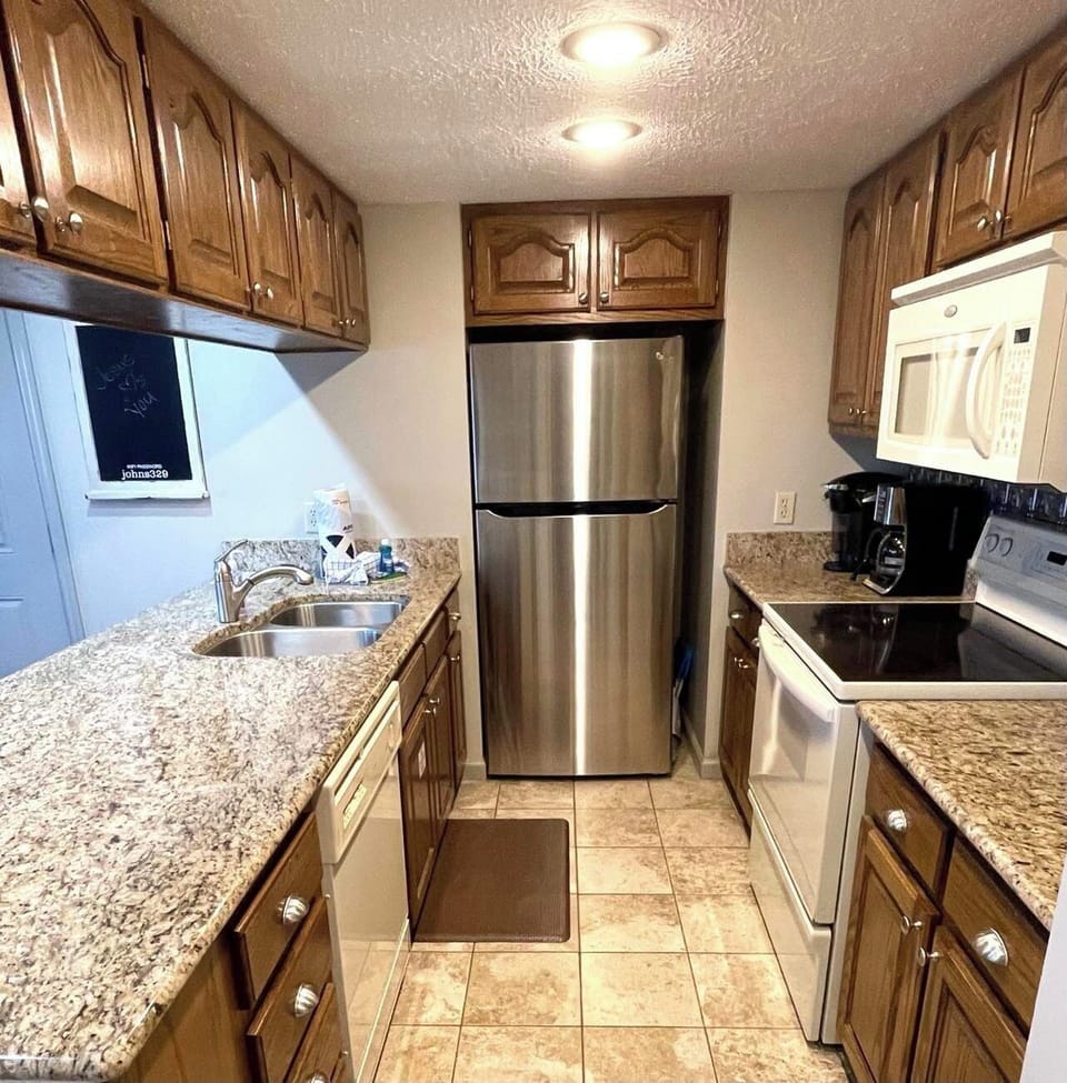 KITCHEN WITH FULL SIZE REFRIGERATOR/ICE MAKER.  REGULAR COFFEE POT AND KEIREG