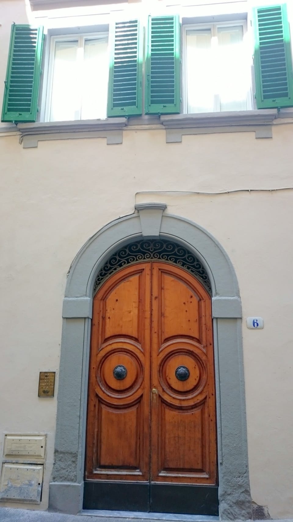 Main door of the building and two windows of Principio Apartment