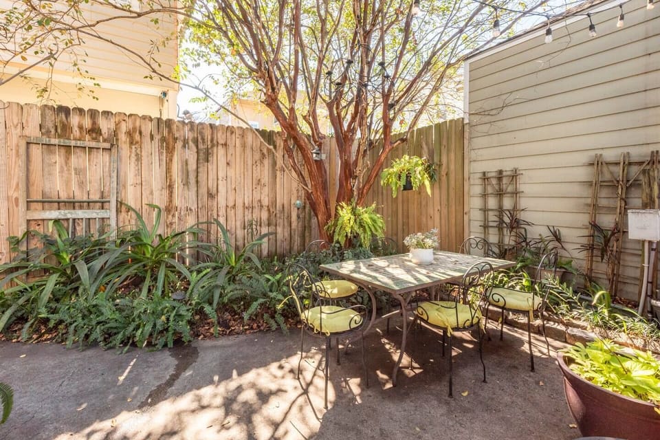 Dine under the crepe myrtle tree on the Spanish mosaic table .
