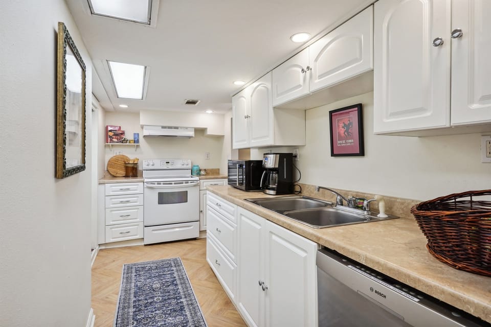 Well appointed kitchen with coffee maker, toaster, microwave, and food processor.