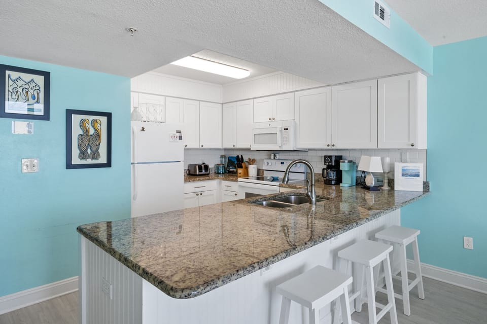 Chef-ready kitchen with seating for three persons at bar
