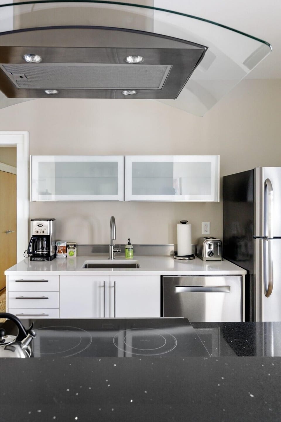 regular drip coffee maker, coffee, filters, creamers, sugar provided in a fully stocked kitchen