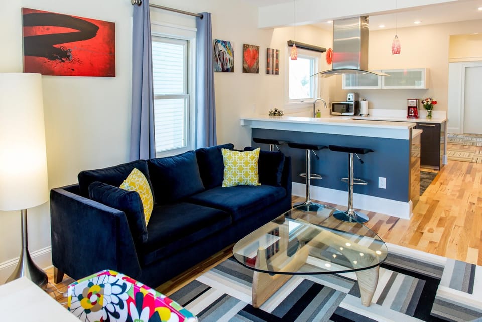 Pops of red art give the living room a fun, edgy vibe.