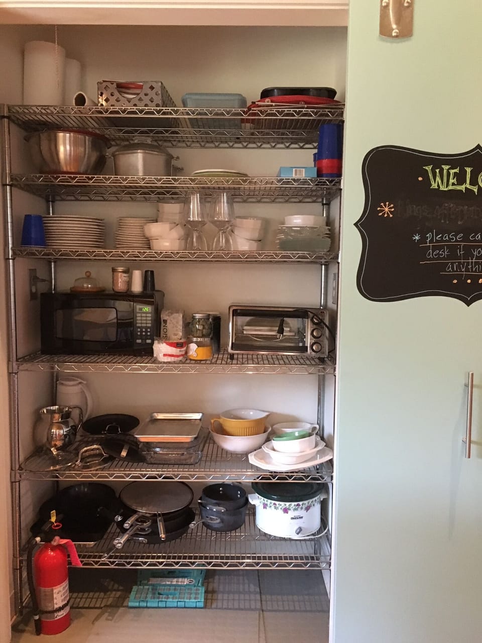 Kitchen closet with details of pots, pans, kitchenware, utensils, etc

