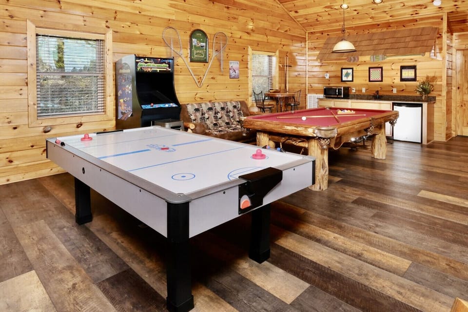 The large loft game room has an air hockey, pool table and arcade