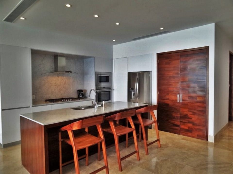 Kitchen with laundry behind wooden doors