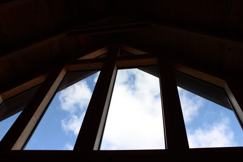 View out of cabin cathedral ceiling on a beautiful day 