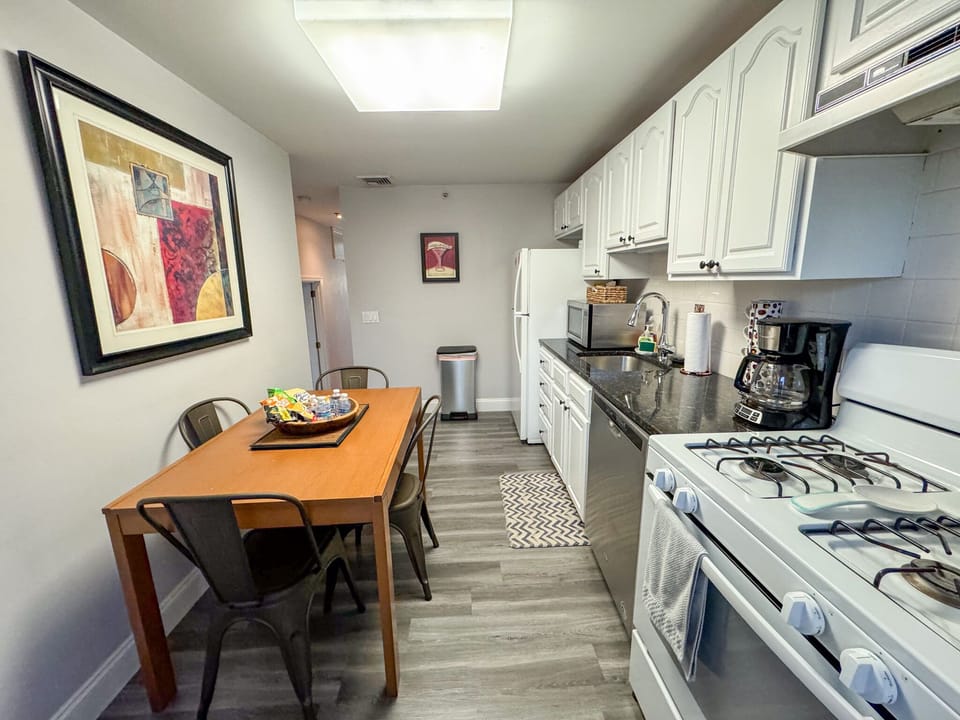 Kitchen: dining table located in kitchen, Kitchen is equipped with dishwasher, gas range, microwave, and many other appliances that are useful in the kitchen