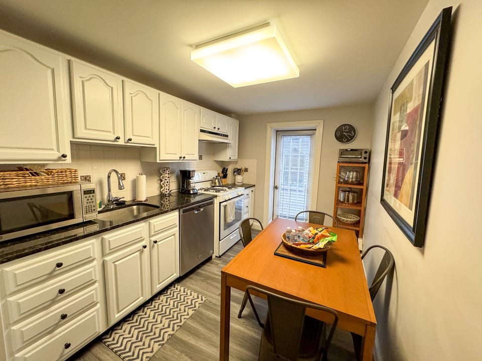 Kitchen: dining table located in kitchen, Kitchen is equipped with dishwasher, gas range, microwave, and many other appliances that are useful in the kitchen