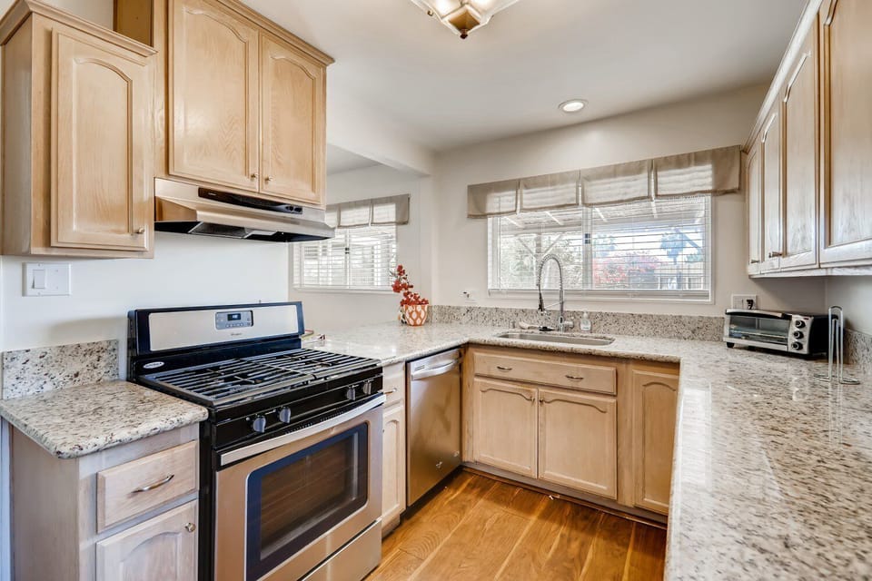 Granite counters, new stainless sink & faucet with bar & stools from kitchen opening up to the dining area. Gas range/oven, refrigerator, microwave, dishwasher, toaster oven, kitchen tools coffee nook stainless appliances in kitchen!