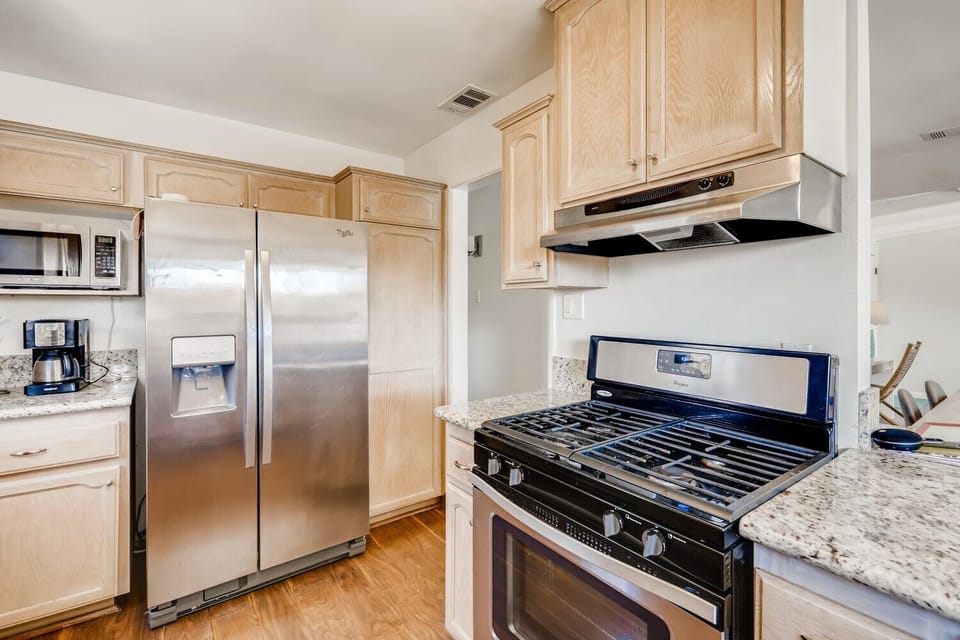 Granite counters, new stainless sink & faucet with bar & stools from kitchen opening up to the dining area. Gas range/oven, refrigerator, microwave, dishwasher, toaster oven, kitchen tools coffee nook stainless appliances in kitchen!