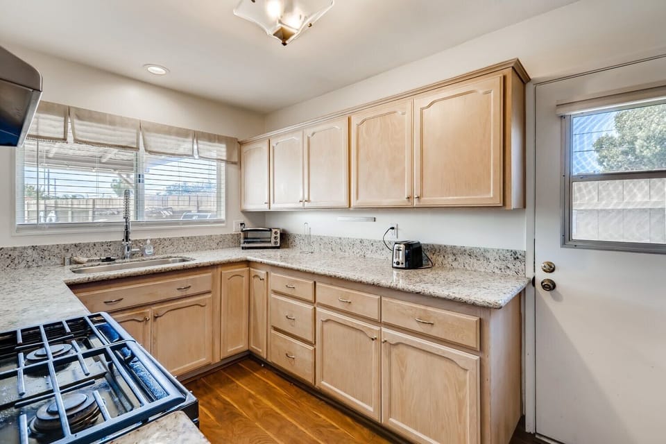 Granite counters, new stainless sink & faucet with bar & stools from kitchen opening up to the dining area. Gas range/oven, refrigerator, microwave, dishwasher, toaster oven, kitchen tools coffee nook stainless appliances in kitchen!
