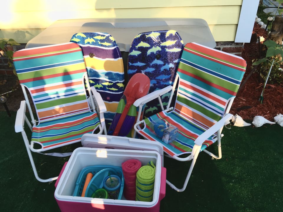 Beach chairs, towels, umbrella, cooler, sand toys available for use  