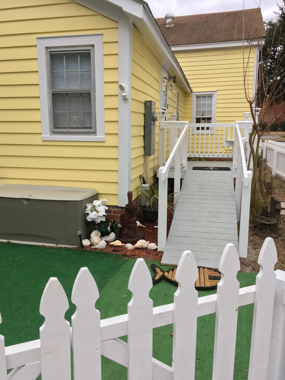 Side porch with ramp at back door entrance. Fenced in back  & side yard .