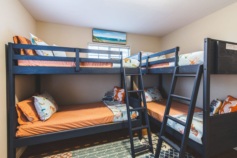 Bunk room.  Pack n Play crib and high chair stored in the closet of this room