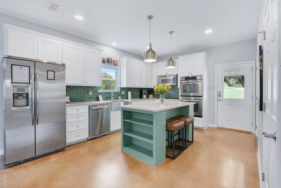 Modern kitchen with stainless appliances.