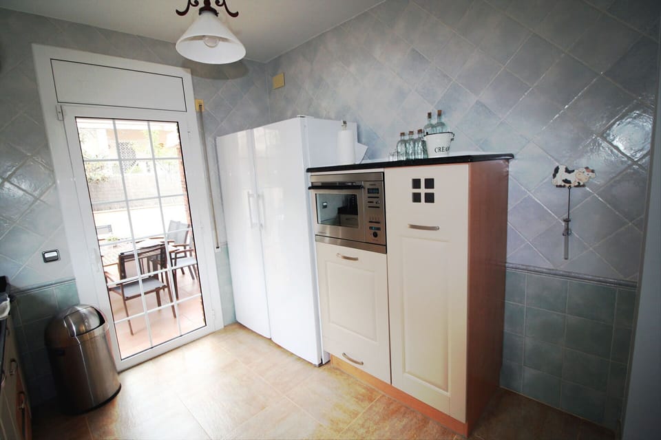 Kitchen with fridge and freezer among others
