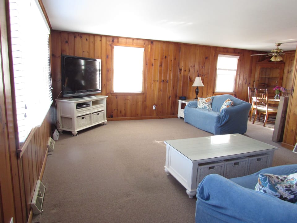   Large living room/dining area   features a 55 in tv, sofa and love seat 