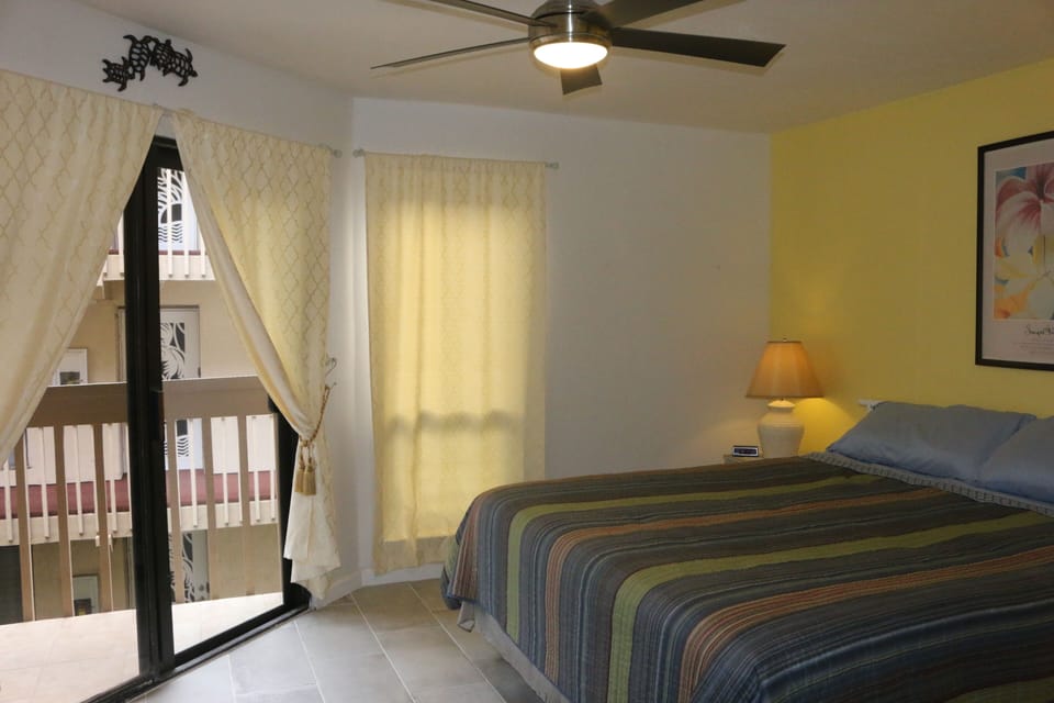 Master bedroom with door to the lanai. California  bed and fan, freshly painted.