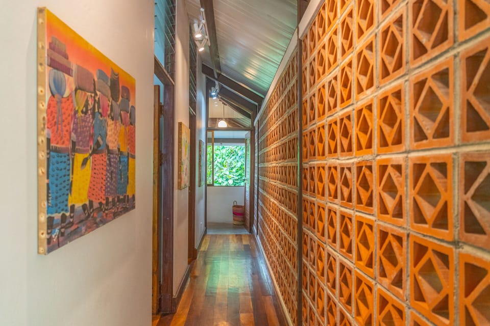 Villa Ginger. A corridor with ventilation wall and art to bedrooms and bath. 