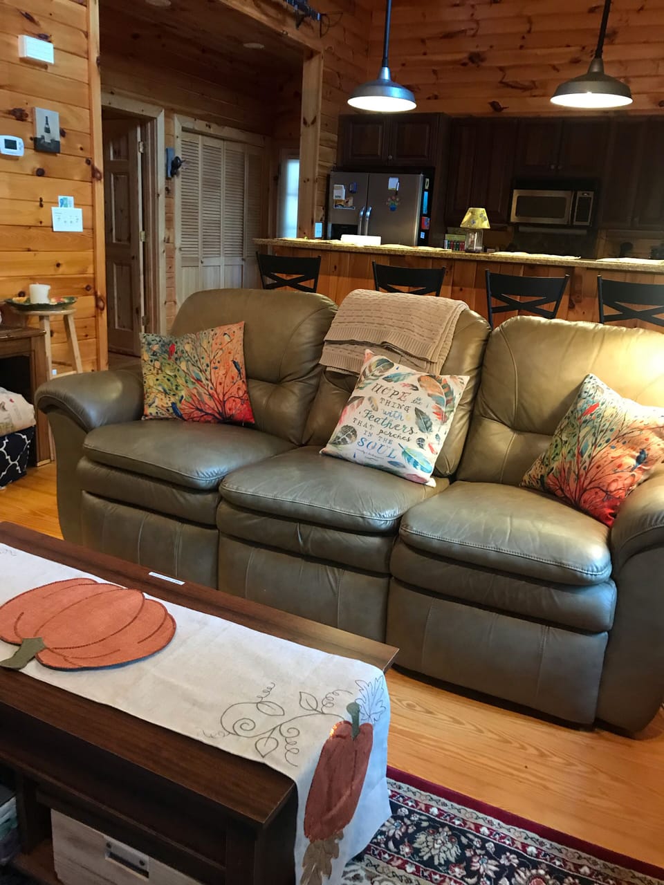 Living room with view of kitchen in the back.