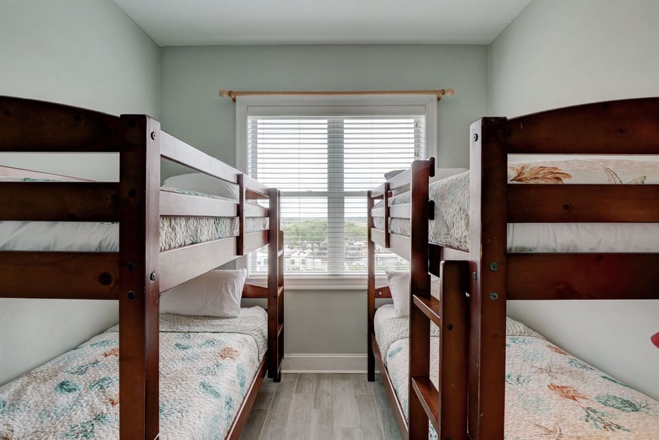 Bunk room with two sets of twin bunk beds and Smart TV