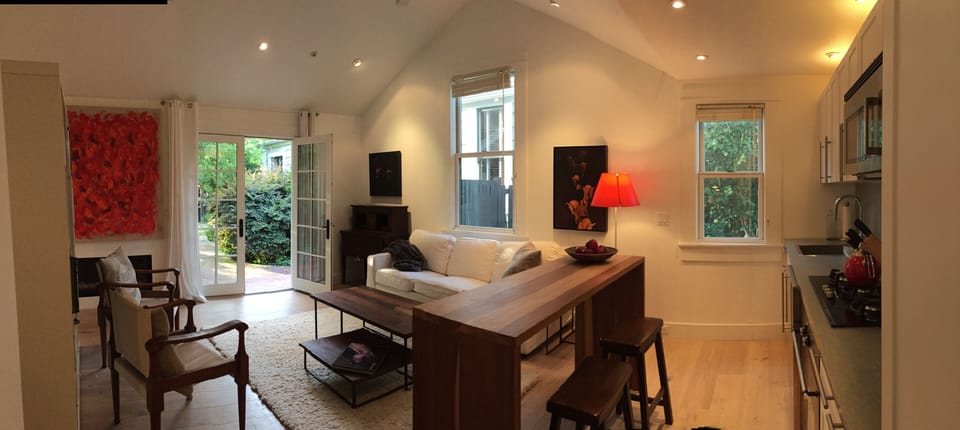Living Room with Queen size Pull out Sofa, Custom Dining Table and Fully Equipped Kitchenette