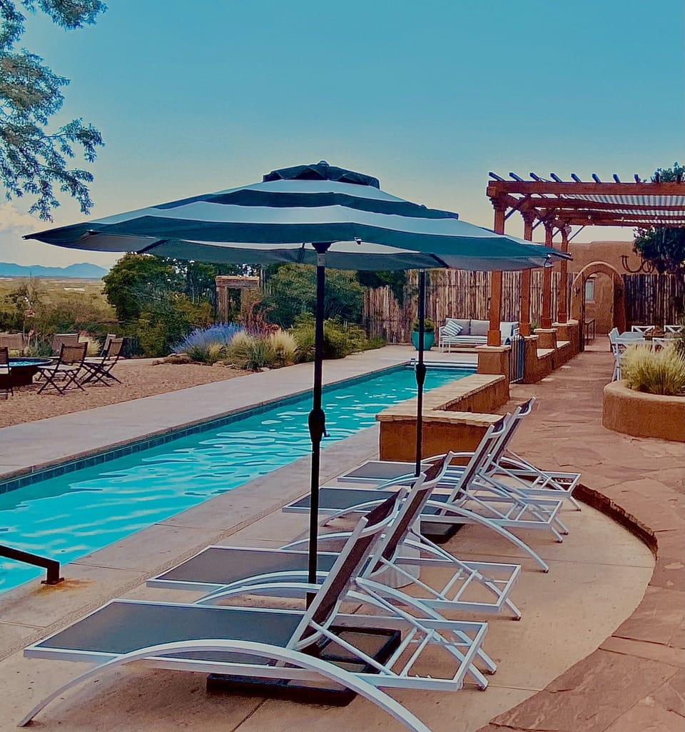 Chaise lounges with umbrellas for lazy pool side days!