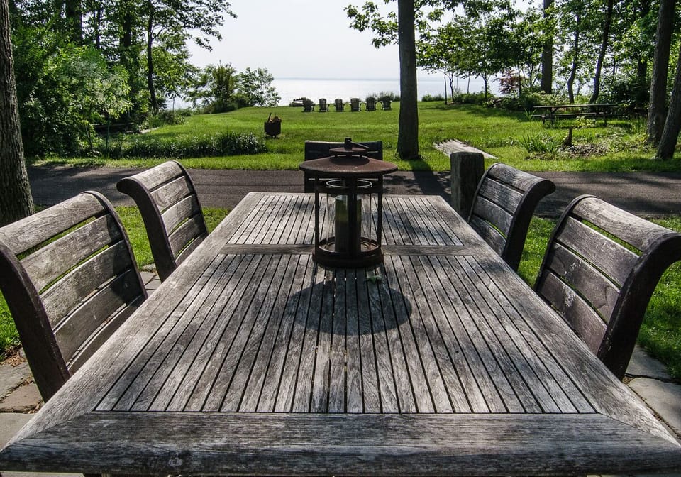 Outdoor dining area overlooking front bluff seating area with sunset views