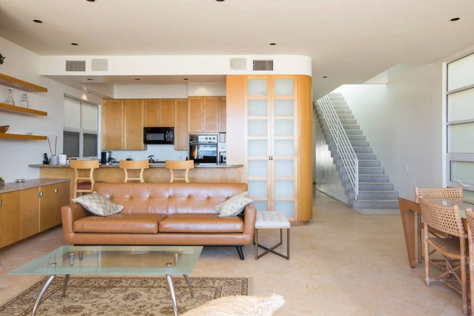 From the sun-bathed & warm Living Room, enjoy the ocean, fireplace and 60" TV