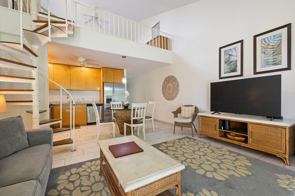 Warm living area w/ comfy seating & soft lighting for easy unwinding.