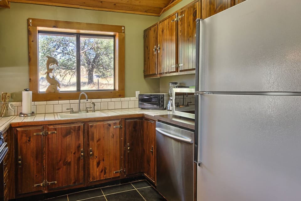 kitchen featuring a quiet dishwasher and a refrigerator. 
