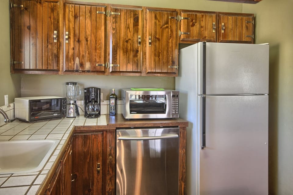 A toaster oven, blender, coffee maker, dishwasher, refrigerator, and freezer