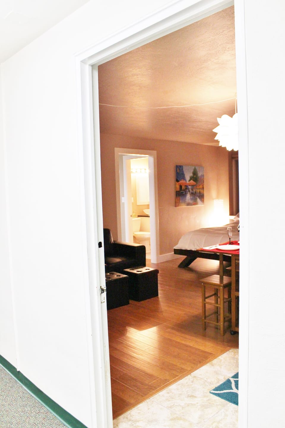 Taken from out in the hallway of the building looking inside the unit.