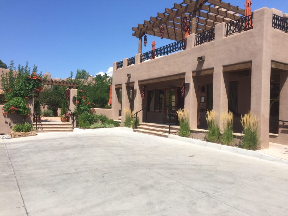 Park Entrance and Clubhouse with outdoor seating upstairs under pergola