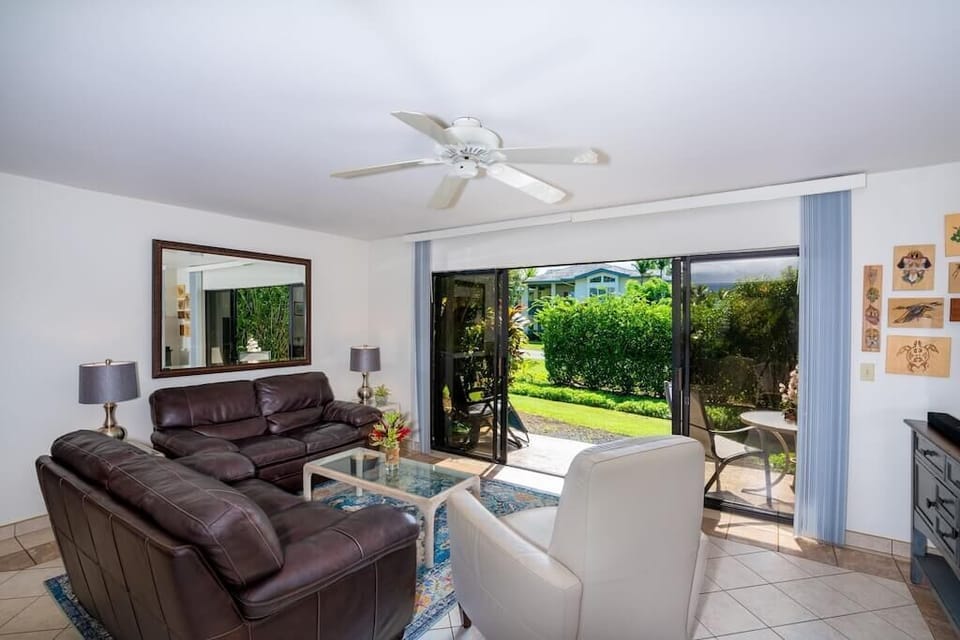 Living Room with Leather Sofas - Ceiling Fan & Tropical Garden Views