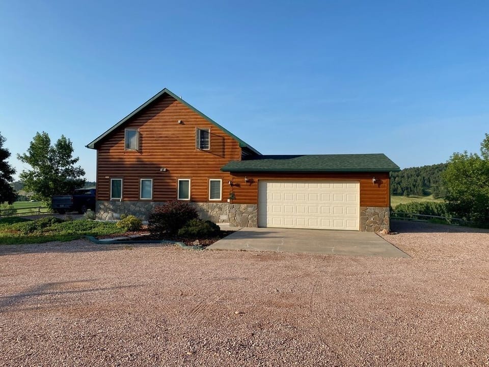 House with driveway view. Garage and outside parking.