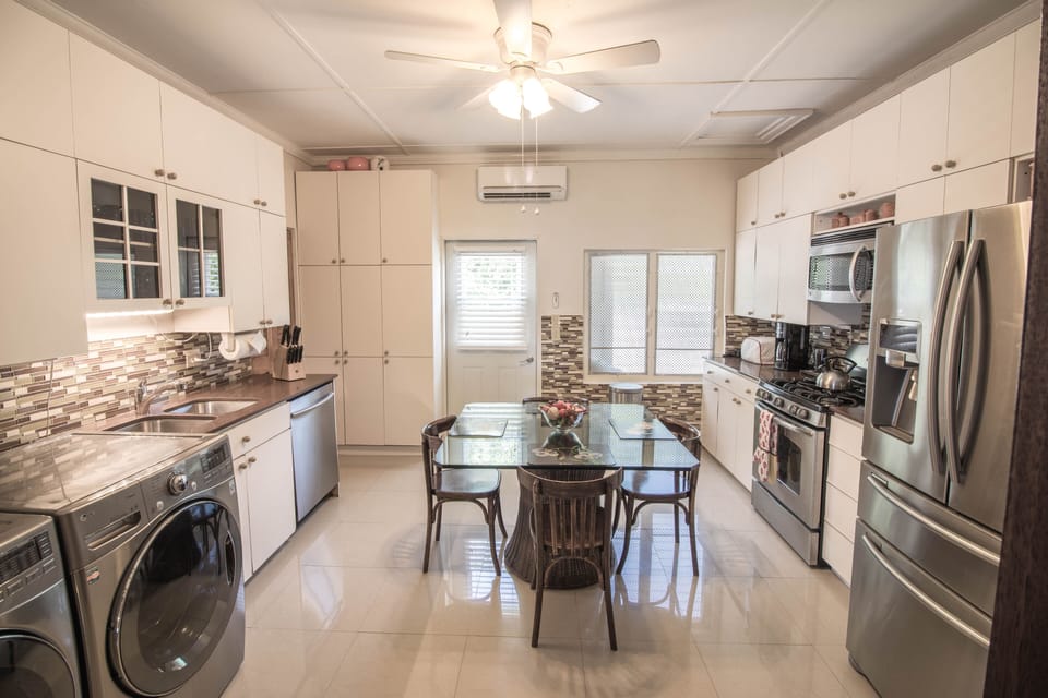 washing machine and dryer conveniently situated in the fully functional kitchen