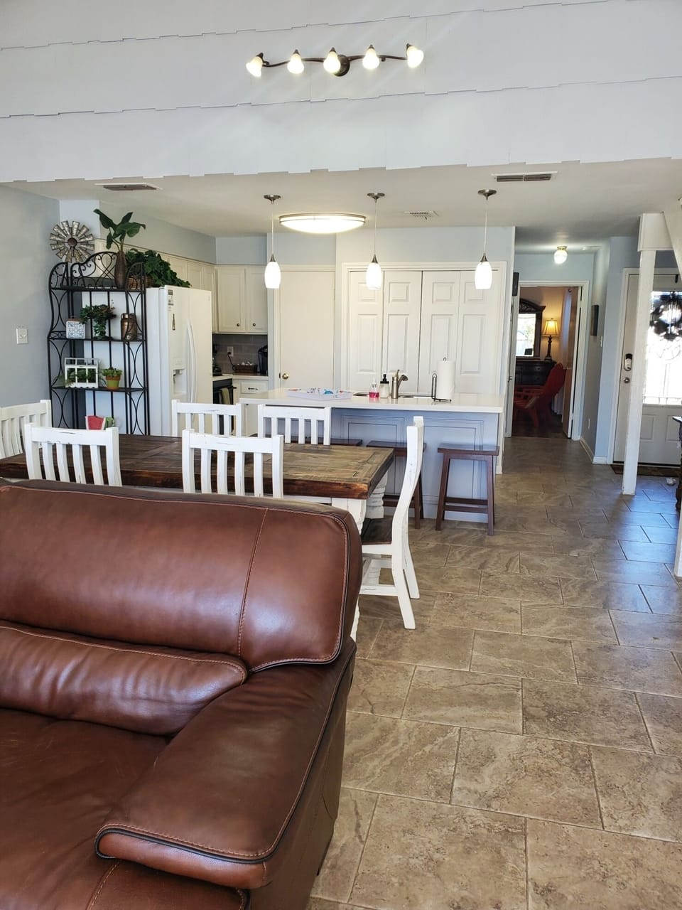 View from the living area into dining and kitchen with new dining table. 
