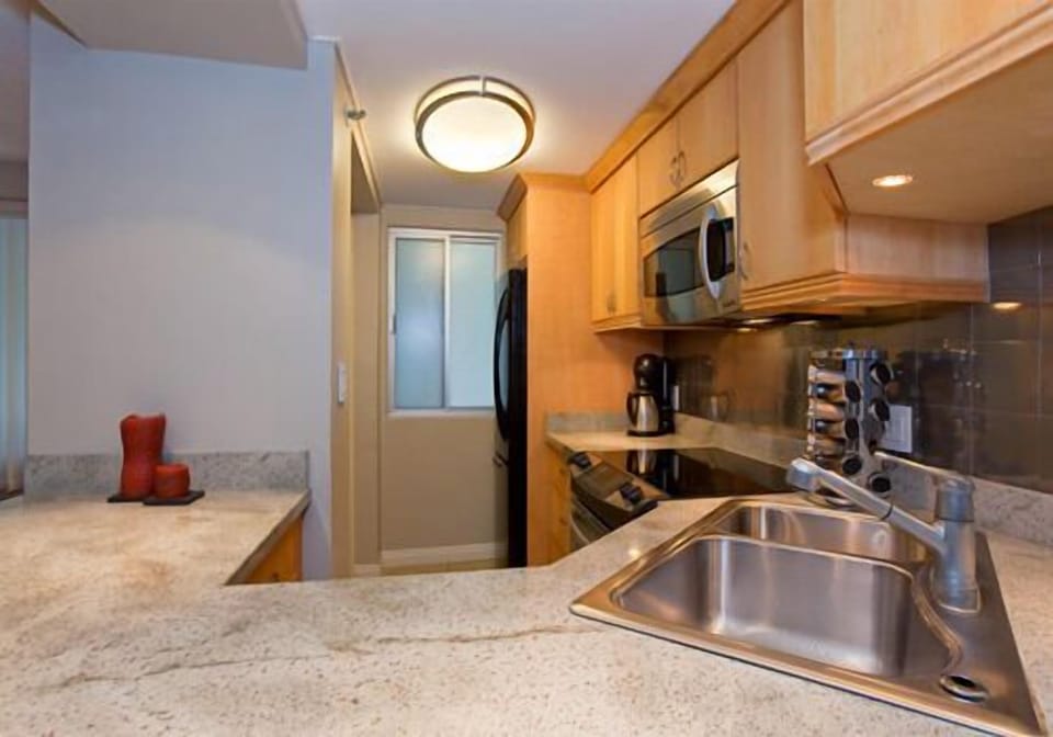 Full kitchen with granite countertops.