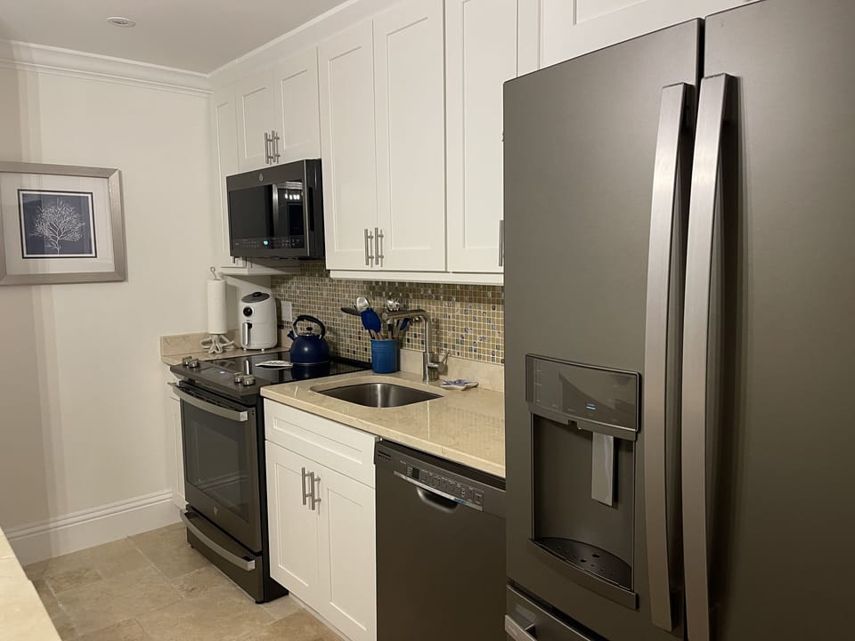Contemporary kitchen with air fryer, k-cup and coffee maker and tea pot