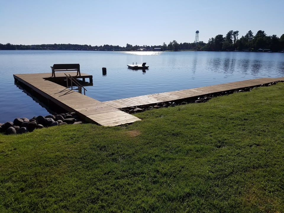 swimming dock with hard sand bottom and swim raft, bench on dock, steps