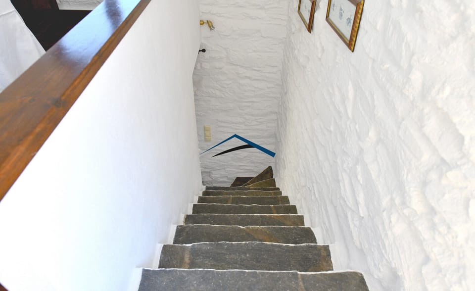 The stairs leading from the living room to the ground floor bedrooms
