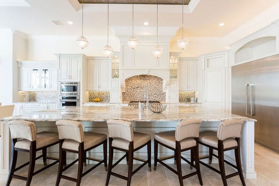 Chef's kitchen with six barstool seating. Great for kids.